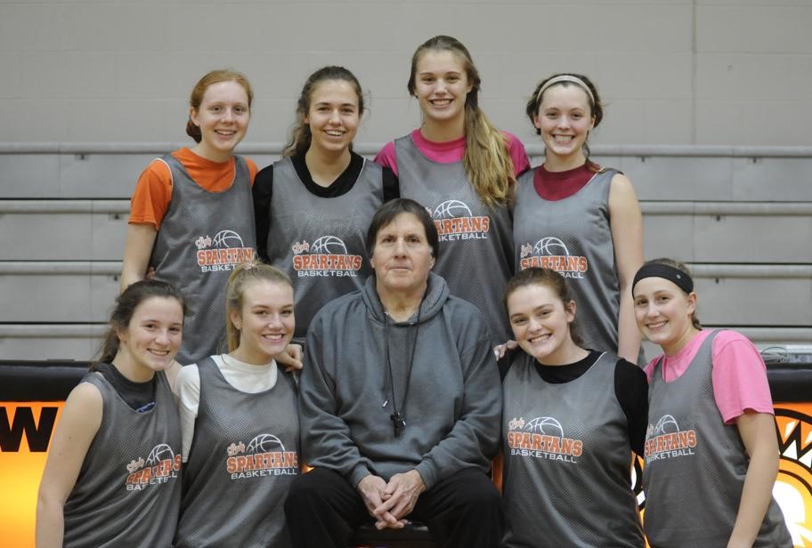 girls basketball team with coach in the middle